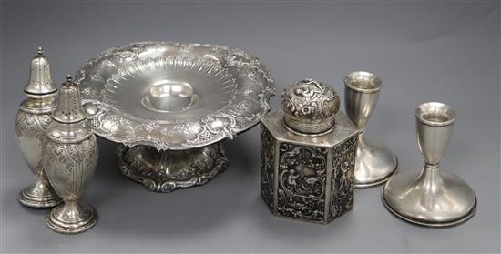 An American sterling tazza, a pair of sterling casters, a pair of sterling dwarf candlesticks and an embossed 800 tea caddy.